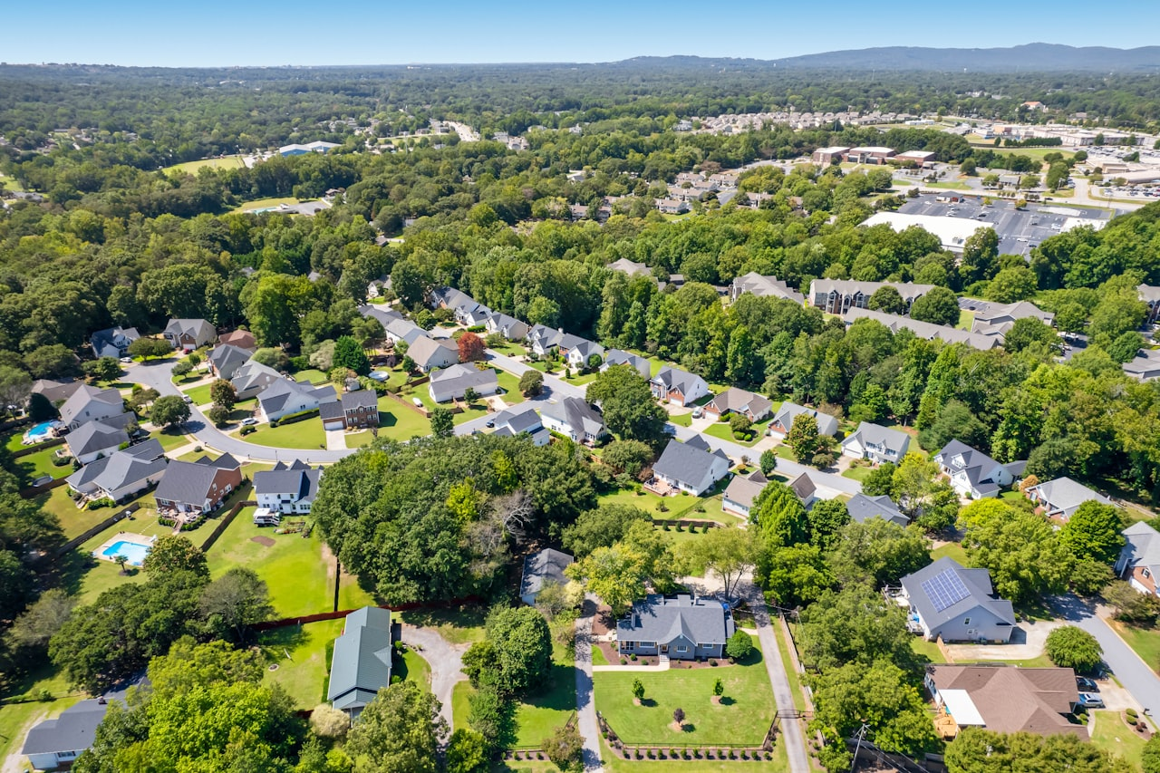 Aerial view of a leafy Sterling Virginia neighborhood with single-family homes and mature trees