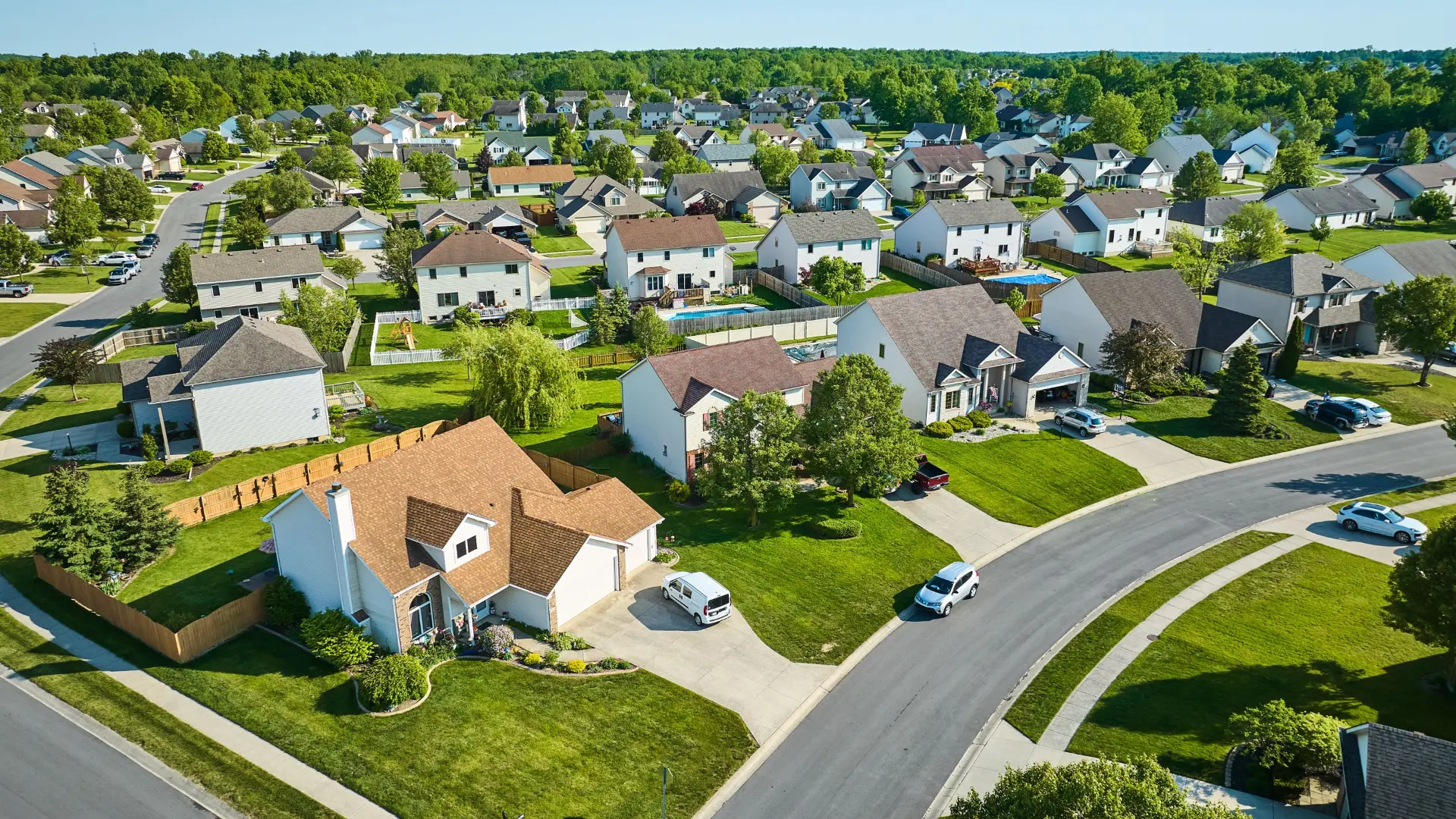 Aerial view of a leafy Ashburn Virginia suburban neighborhood with modern homes and green lawns
